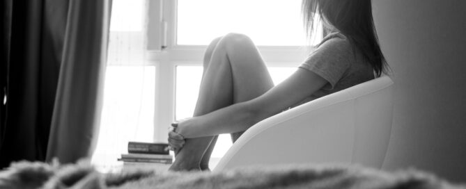 person experiencing anxiety sitting calmly reflective moment soft lighting