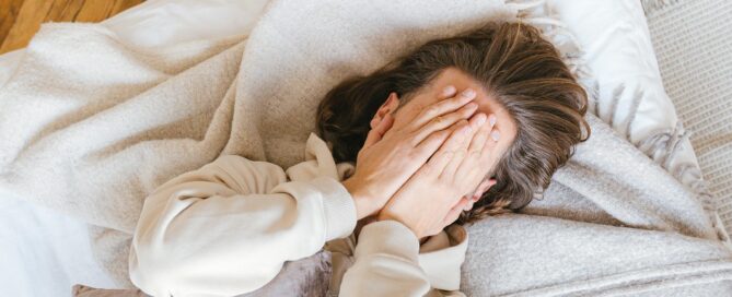 teen experiencing burnout with hands over face overwhelmed