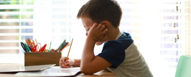 Child completing schoolwork while experiencing signs of anxiety or ADHD