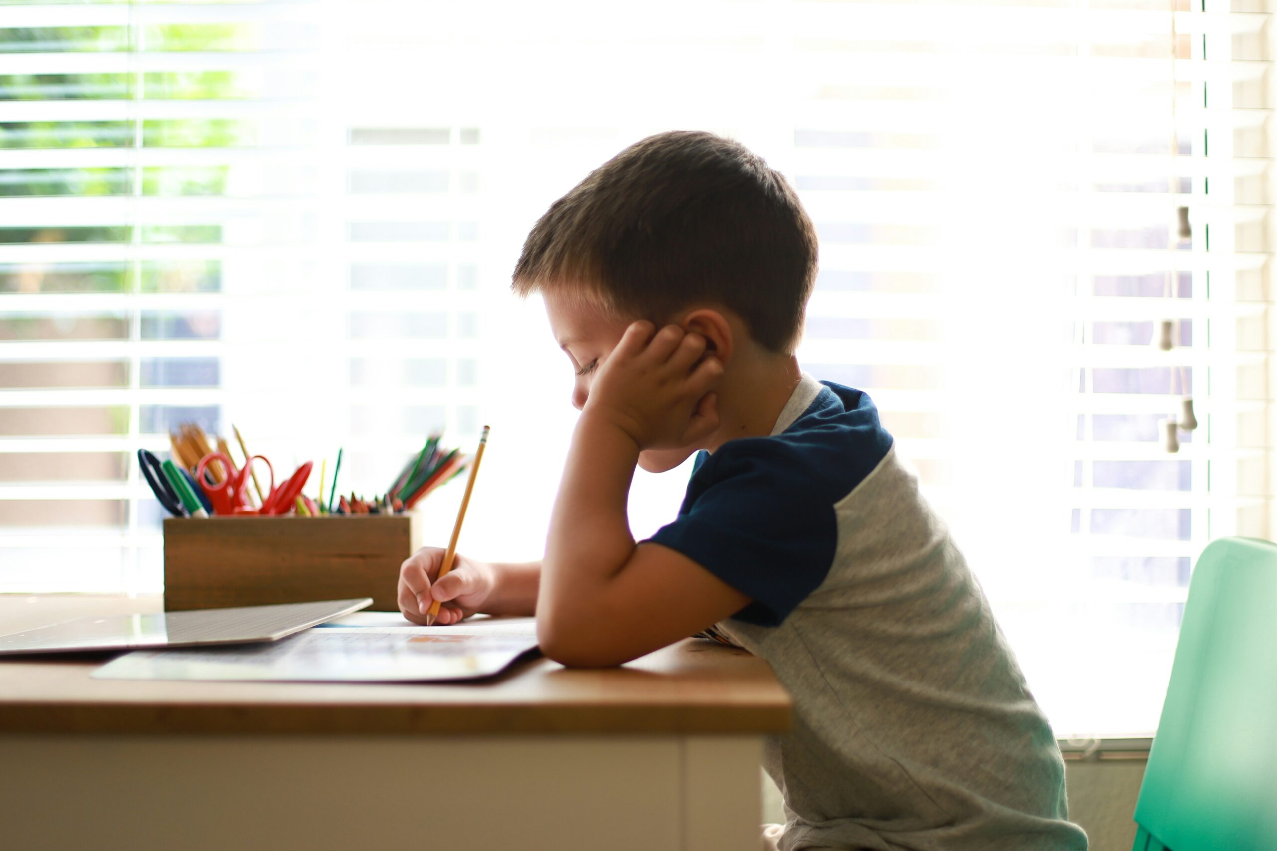 Child completing schoolwork while experiencing signs of anxiety or ADHD